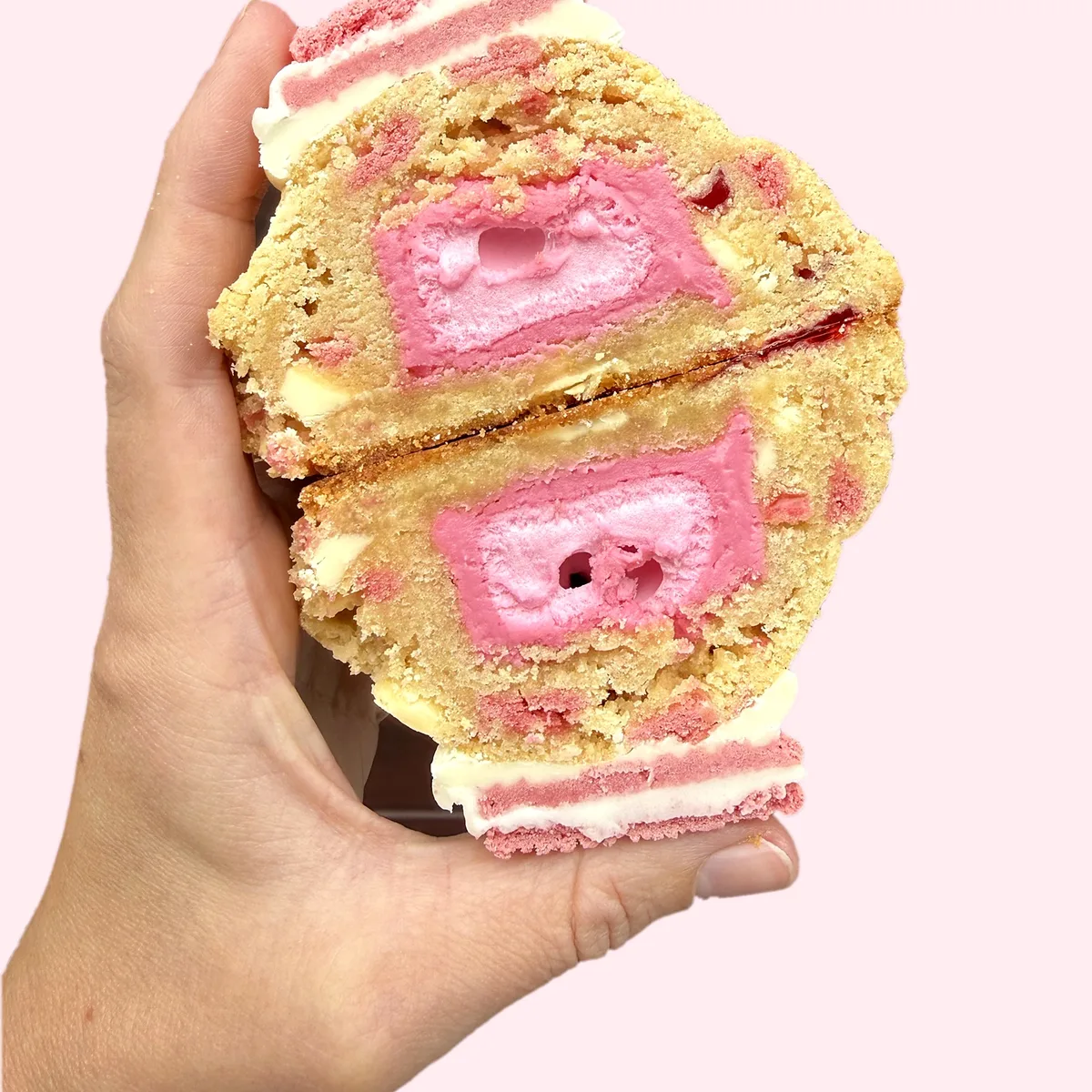 Marshmallow Oreo cookie cut in half, showing a pink marshmallow centre